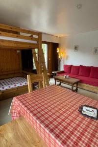 een woonkamer met een bed en een bank bij Apartment Les Aiguilles du Brévent by Interhome in Chamonix-Mont-Blanc