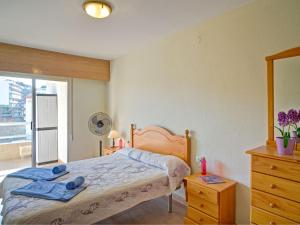 a bedroom with a bed and a dresser and a window at Apartment Apolo IV-6 by Interhome in Calpe