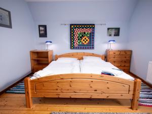 ノルデンにあるHoliday Home Kleen by Interhomeのベッドルーム1室(木製ベッド1台、ドレッサー2台付)
