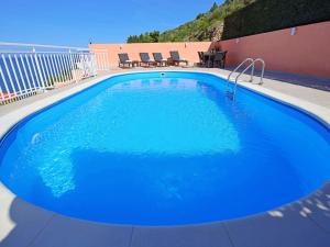 een groot blauw zwembad op een patio bij Holiday Home Damjanović by Interhome in Prigradica