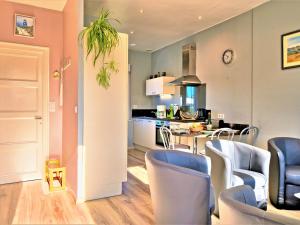 a kitchen and living room with a table and chairs at Holiday Home La Corvette by Interhome in Pléneuf-Val-André