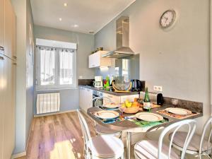 a kitchen with a table with chairs and a counter top at Holiday Home La Corvette by Interhome in Pléneuf-Val-André