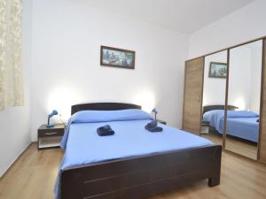 a bedroom with a bed and a large mirror at Holiday Home Franko 2 - MDN185 by Interhome in Ližnjan