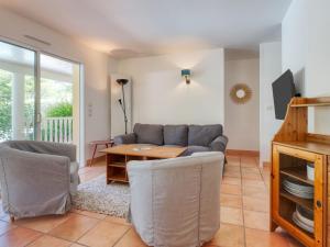 a living room with a couch and a table at Holiday Home Eden Parc by Interhome in Lacanau-Océan