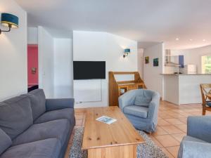 a living room with a couch and chairs and a table at Holiday Home Eden Parc by Interhome in Lacanau-Océan +34 photos