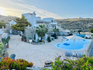 a villa with a swimming pool and a resort at Navy Blue Suites in Ornos