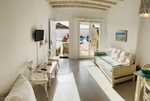 a living room with a couch and a table at Navy Blue Suites in Ornos