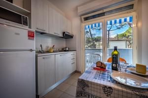 eine Küche mit einem Tisch und einer Flasche Wein in der Unterkunft Residence Mareblù in Principina a Mare