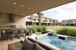 a patio with a hot tub and a table and chairs at Magic Village Views Trademark Collection by Wyndham in Orlando