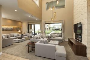 a living room with white couches and a tv at Magic Village Views Trademark Collection by Wyndham in Orlando