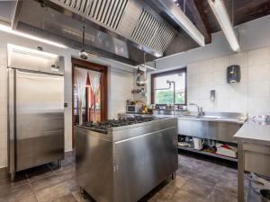 a kitchen with a stainless steel stove and sink at Holiday Home La Grotta di Cech by Interhome in Narzole