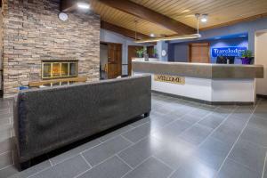 a lobby of a hotel with a fireplace at Travelodge by Wyndham Appleton in Appleton
