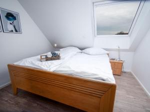 a bed in a room with a window at Apartment Sanddüne by Interhome in Norddeich