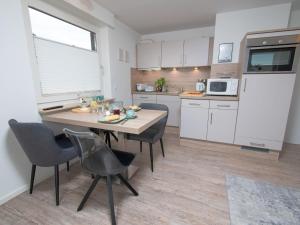 a kitchen and dining room with a table and chairs at Apartment Sanddüne by Interhome in Norddeich +37 photos