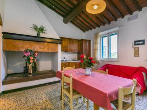 a living room with a table and a fireplace at Apartment Fattoria Petraglia - Di Mezzo - MTG202 by Interhome in Monteriggioni