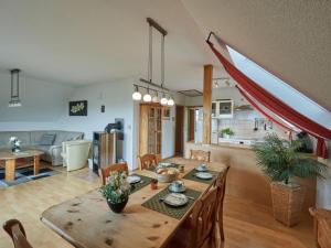 a dining room and living room with a table and chairs at Apartment Grandpa by Interhome in Frankenau