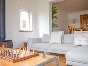 a living room with a chess board on a coffee table at Holiday Home Bay View by Interhome in Uig +29 photos