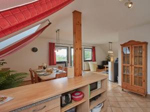a kitchen and living room with a table and a dining room at Apartment Grandpa by Interhome in Frankenau