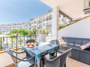 a table and chairs on the balcony of a apartment at Apartment Sant Maurici-22 by Interhome in Empuriabrava