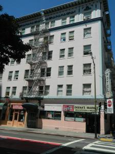 a large white building on the corner of a street at Admiral Hotel in San Francisco