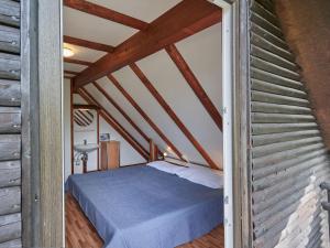 a bedroom with a bed in a attic at Holiday Home Aschenputtel by Interhome in Frankenau