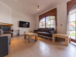 a living room with couches and tables and a tv at Holiday Home Residencial Port Lligat by Interhome in Torredembarra