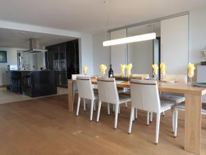 a dining room and kitchen with a table and chairs at Apartment L'Esplanade A3-8 by Interhome in Montreux