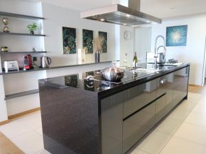 a kitchen with a large black counter with a sink at Apartment L'Esplanade A3-8 by Interhome in Montreux