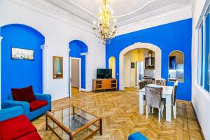 - un salon avec des murs bleus, une table et des chaises dans l'établissement Apartment Nizami Street 5 room, à Baku
