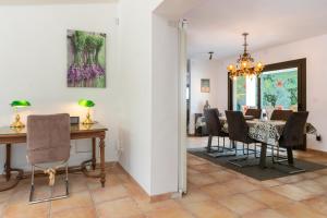 a dining room with a table and chairs at Villa Aurora in Llagostera
