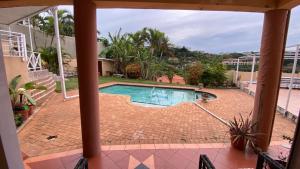 a view of a swimming pool from a house at La Lucia Ridge Self Catering Penthouse Environment in Durban