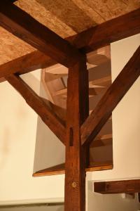 a wooden table with wooden beams on a ceiling at Kleines Ferienhaus in Umkirch in Umkirch