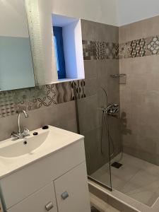 a bathroom with a sink and a shower at Almira Studios and Apartments in Agia Marina +66 photos