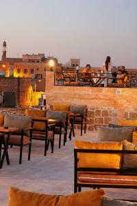 a group of people sitting on the roof of a building at Mons Masius Boutique Hotel Cafe in Midyat