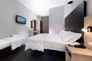 Postel nebo postele na pokoji v ubytování Hotel Aiglon