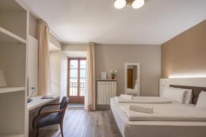 Postel nebo postele na pokoji v ubytování Hotel Il Portico by LVG Hotel Collection