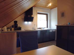 a kitchen with a sink and a counter top at Ferienwohnung am Wald in Unterlüß