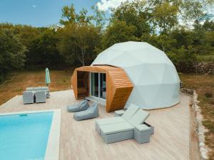 a dome house with a swimming pool in front of it at Pura - Home in Nature in Oliveira do Hospital