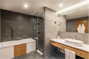 a bathroom with a sink and a shower at Holiday Inn Yerevan - Republic Square, an IHG Hotel in Yerevan