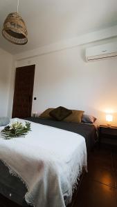 a bedroom with a large bed with flowers on it at Villa Moiko in La Parra +36 photos