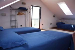 a bedroom with two blue beds and a ladder at Villa Bruna in Trogir