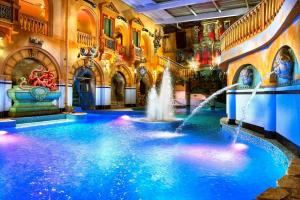 a pool in the middle of a building with water fountains at Chalupa pod Modřínem in Kořenov