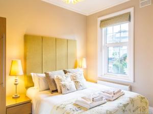 a bedroom with a bed with two towels on it at Alum Chine Beach House in Bournemouth