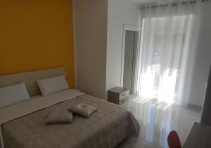 - une chambre avec un lit avec deux oreillers et une fenêtre dans l'établissement Locazione turistica Totaro, à Vico del Gargano