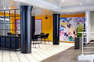 a lobby with black columns and a colorful wall at Cabinn Scandinavia in Copenhagen