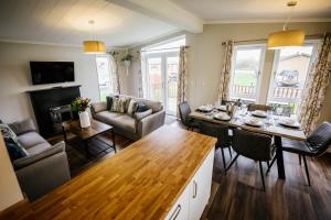 a living room with a dining table and a living room at Ream Hills Holiday Park in Blackpool