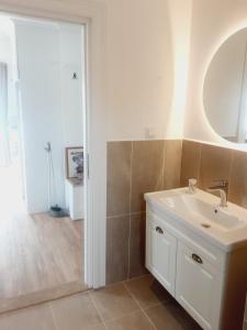 a bathroom with a white sink and a mirror at Beach House Hotel in Side