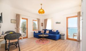 a living room with a blue couch and a table at Beach House Hotel in Side