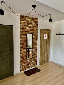 an empty room with a brick wall and a door at Old Tree Home & Restaurant in Oświęcim
