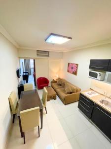 a kitchen and living room with a couch and a table at Bella Rosa Hotel in Beirut